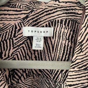 Pink and black print Topshop blouse. Full sleeves, button and tie detail.